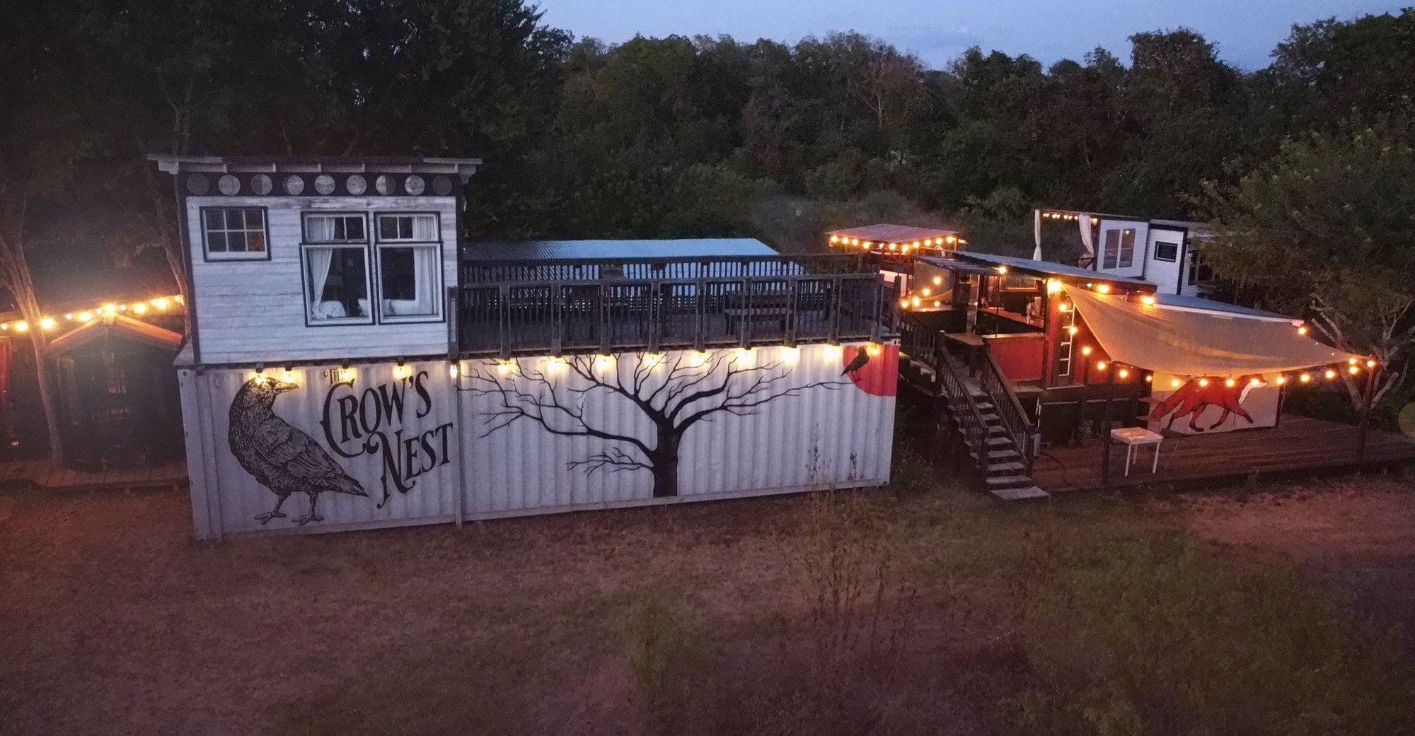 The Crows Nest cabin lit up at dusk
